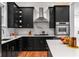 Sleek kitchen featuring black cabinetry, stainless steel appliances, and hexagon tile backsplash at 132 Olympic Pl, Decatur, GA 30030