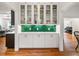 A built-in cabinet with glass doors and green backsplash is featured in a living room at 132 Olympic Pl, Decatur, GA 30030