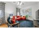 Inviting living room with a comfortable orange sectional, blue armchair, and world map wall decor at 132 Olympic Pl, Decatur, GA 30030