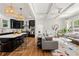 Open-concept kitchen and living area with coffered ceilings, black cabinetry, and stylish decor at 132 Olympic Pl, Decatur, GA 30030
