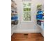 A walk-in pantry features white wire shelves, a window, and wood floors at 132 Olympic Pl, Decatur, GA 30030