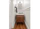 Charming powder room with a stylish vanity, modern sink faucet and wood look floors at 132 Olympic Pl, Decatur, GA 30030