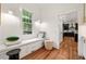 A reading nook with window seat storage, a window, and hardwood floors is featured at 132 Olympic Pl, Decatur, GA 30030