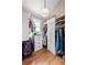 Organized walk-in closet with custom shelving, drawers, hardwood flooring, and natural light from a window at 132 Olympic Pl, Decatur, GA 30030