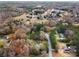 High-angle view of the property, emphasizing its scenic neighborhood setting with mature trees and nearby residences at 247 Mandy Ct, Mcdonough, GA 30252