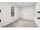 Empty bedroom featuring carpet, neutral walls, and window providing natural light at 247 Mandy Ct, Mcdonough, GA 30252