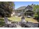 Beautiful backyard featuring a stone firepit, screened-in porch, patio, and well-maintained lawn at 4044 Kenway Se Pl, Smyrna, GA 30082