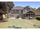 Large backyard with a patio, screened-in porch, and plenty of green space at 4044 Kenway Se Pl, Smyrna, GA 30082