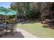 Lush backyard featuring a patio, outdoor seating, and beautiful landscaping at 4044 Kenway Se Pl, Smyrna, GA 30082