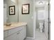 Well-lit half bathroom with white cabinets and patterned flooring at 4044 Kenway Se Pl, Smyrna, GA 30082