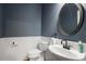 Bathroom features modern fixtures, wainscotting, and a stylish oval mirror at 4044 Kenway Se Pl, Smyrna, GA 30082