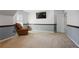 Spacious bonus room with a comfortable recliner and entertainment setup at 4044 Kenway Se Pl, Smyrna, GA 30082