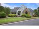 Community clubhouse featuring stone and gray siding and beautiful landscaping at 4044 Kenway Se Pl, Smyrna, GA 30082