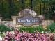 Stone sign at the entrance to King Valley at Vinings surrounded by lush greenery at 4044 Kenway Se Pl, Smyrna, GA 30082