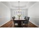Elegant dining room with hardwood floors, a chandelier, and ample natural light through shuttered windows at 4044 Kenway Se Pl, Smyrna, GA 30082