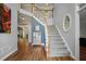 Elegant foyer with hardwood floors, staircase, and neutral paint, creating a welcoming entrance at 4044 Kenway Se Pl, Smyrna, GA 30082