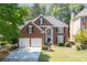 Charming two-story brick home with a well-manicured lawn and a classic front door at 4044 Kenway Se Pl, Smyrna, GA 30082