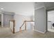 Well-lit upstairs hallway with hardwood railing and view of laundry room at 4044 Kenway Se Pl, Smyrna, GA 30082