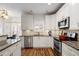 Modern kitchen features granite countertops, stainless steel appliances, and white cabinetry at 4044 Kenway Se Pl, Smyrna, GA 30082