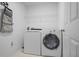 Efficient laundry room equipped with a washer, dryer, and wire shelving at 4044 Kenway Se Pl, Smyrna, GA 30082
