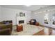 Bright living room features a fireplace, hardwood floors, and access to patio at 4044 Kenway Se Pl, Smyrna, GA 30082
