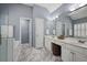 Well-lit main bathroom with a double sink vanity and large-format floor tiles at 4044 Kenway Se Pl, Smyrna, GA 30082