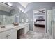Well-lit main bathroom offering a double sink vanity and a seamless glass shower at 4044 Kenway Se Pl, Smyrna, GA 30082