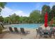 Community pool area with multiple lounge chairs and tables for residents to enjoy at 4044 Kenway Se Pl, Smyrna, GA 30082