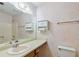 Vintage-style bathroom featuring a single sink vanity and a shower-tub combination at 502 Knollwood Pl, Woodstock, GA 30188
