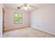 Bedroom with carpeted floors, a ceiling fan, and a window letting in ample natural light at 502 Knollwood Pl, Woodstock, GA 30188