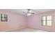 Pink bedroom featuring a ceiling fan and two windows letting in ample natural light at 502 Knollwood Pl, Woodstock, GA 30188