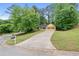 Spacious home on a large lot featuring a long drive way and mature trees at 502 Knollwood Pl, Woodstock, GA 30188