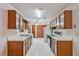 Galley kitchen with plenty of wood cabinets, white appliances and laminate counters at 502 Knollwood Pl, Woodstock, GA 30188