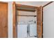 Utility closet with wood doors featuring a side-by-side washer and dryer set at 502 Knollwood Pl, Woodstock, GA 30188