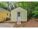Backyard shed with a ramp nestled among lush greenery in a backyard setting at 502 Knollwood Pl, Woodstock, GA 30188