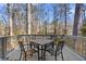 Enjoy outdoor dining on the spacious back deck surrounded by trees at 7000 Woodland Nw Pl, Kennesaw, GA 30152