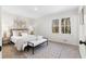 Cozy bedroom featuring a comfortable bed, bench, decor, and a view from the bright window at 7000 Woodland Nw Pl, Kennesaw, GA 30152