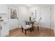 Cozy dining area with a round table, four chairs, and natural light streaming through the door at 7000 Woodland Nw Pl, Kennesaw, GA 30152