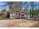 Charming single-story home featuring a welcoming front porch and well-maintained landscaping at 7000 Woodland Nw Pl, Kennesaw, GA 30152