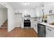 Well-equipped kitchen with white cabinets, stainless steel appliances, and convenient layout at 7000 Woodland Nw Pl, Kennesaw, GA 30152