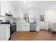 Bright and modern kitchen with white cabinets, stainless steel appliances, and sleek countertops at 7000 Woodland Nw Pl, Kennesaw, GA 30152