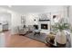 Inviting living room featuring a cozy fireplace, stylish decor, and comfortable seating arrangements at 7000 Woodland Nw Pl, Kennesaw, GA 30152