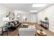 Spacious living room features modern decor, comfortable seating, and ample natural light at 7000 Woodland Nw Pl, Kennesaw, GA 30152