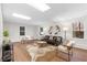 Bright living room with modern furniture, stylish decor, and windows providing natural light at 7000 Woodland Nw Pl, Kennesaw, GA 30152