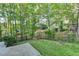 Beautiful backyard with mature trees, lush lawn, and privacy at 986 Franklin Ridge Ct, Sugar Hill, GA 30518