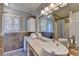 Bathroom featuring natural light, vanity, tiled walls, and a shower with curtain at 986 Franklin Ridge Ct, Sugar Hill, GA 30518
