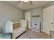 Bedroom featuring neutral walls, white doors, neutral carpeting and crib at 986 Franklin Ridge Ct, Sugar Hill, GA 30518