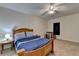 Bedroom features a ceiling fan, plush carpet, and natural light at 986 Franklin Ridge Ct, Sugar Hill, GA 30518
