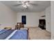 Large bedroom with natural light, plush carpet, ceiling fan, and TV at 986 Franklin Ridge Ct, Sugar Hill, GA 30518