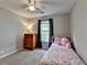 Cozy bedroom with a window, plush carpet, and soft natural light at 986 Franklin Ridge Ct, Sugar Hill, GA 30518